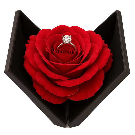 Open black rose ring box with red flower holding engagement ring