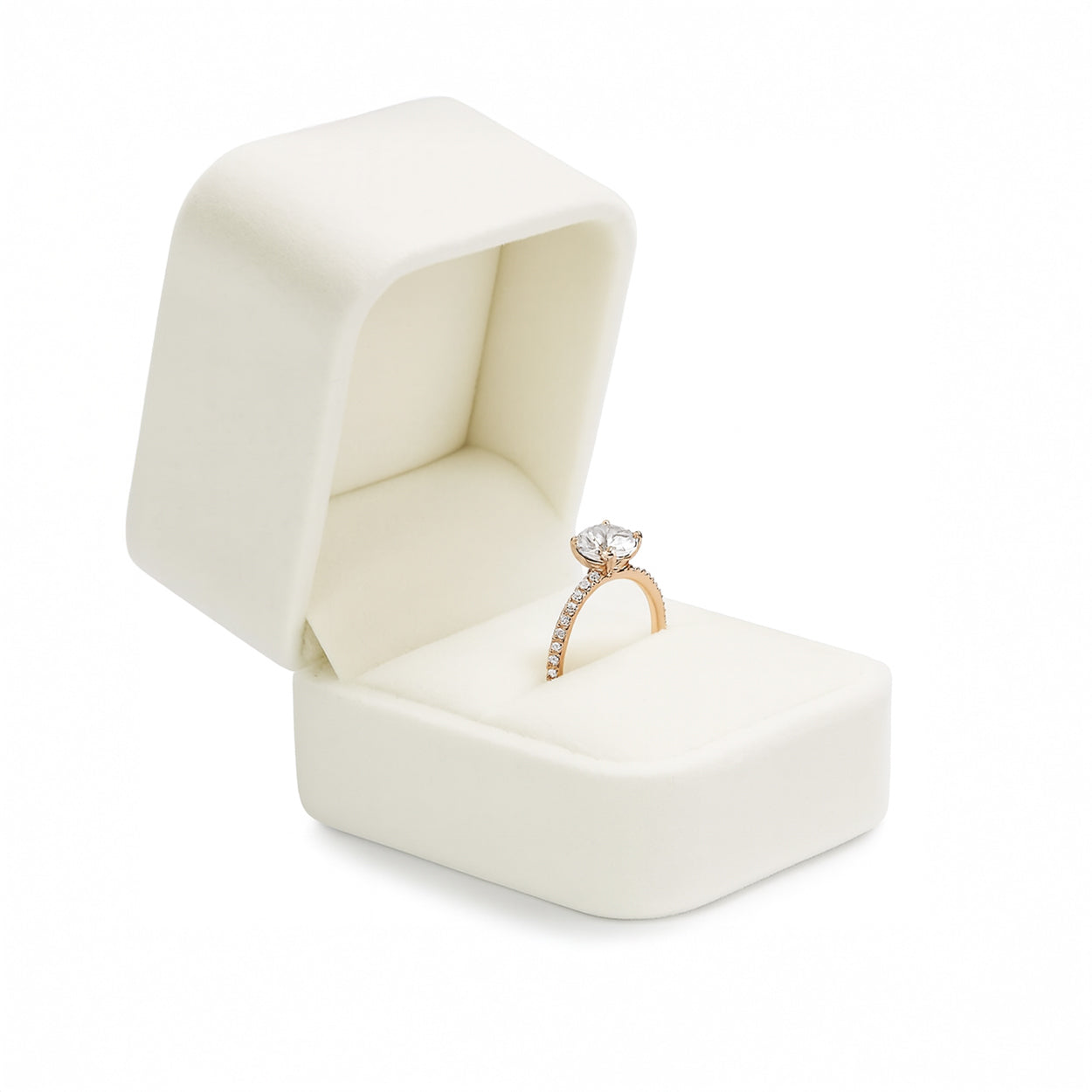 Open ivory velvet ring box holding rose gold diamond engagement ring