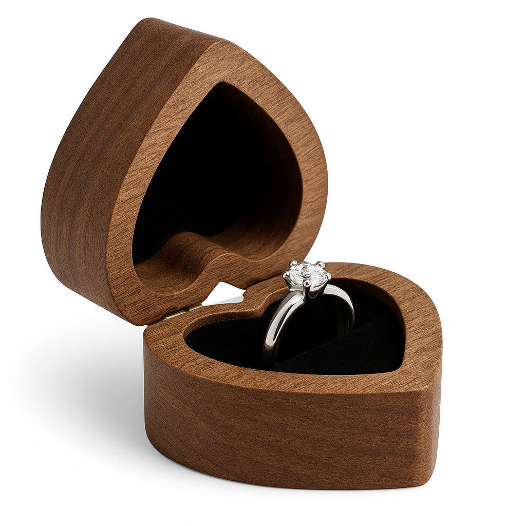 Open walnut heart shaped ring box with black velvet interior holding engagement ring