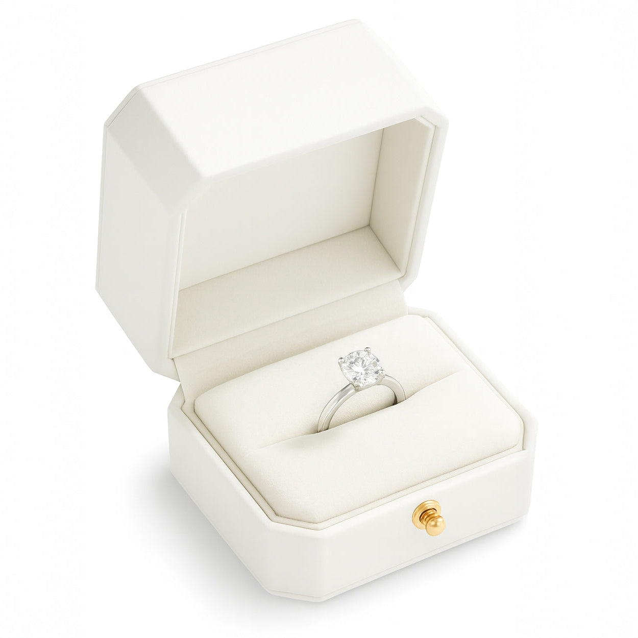 Open white luxury ring box with diamond button holding engagement ring