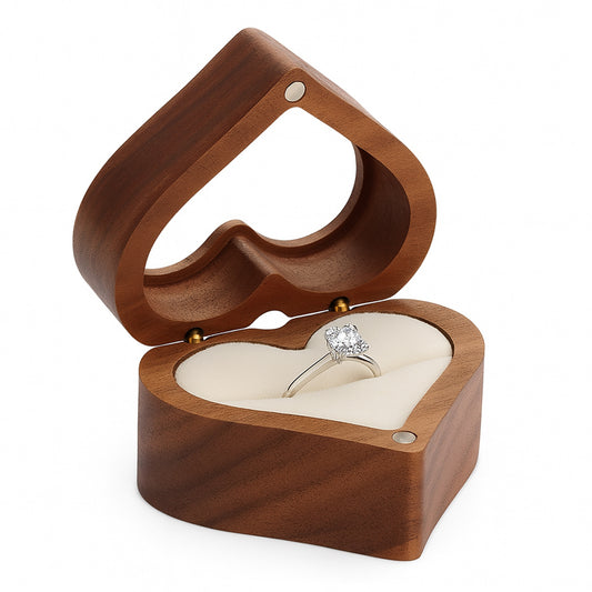 Open wooden heart shaped ring box with engagement ring inside